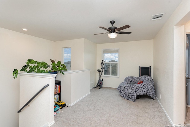 sitting room featuring light carpet