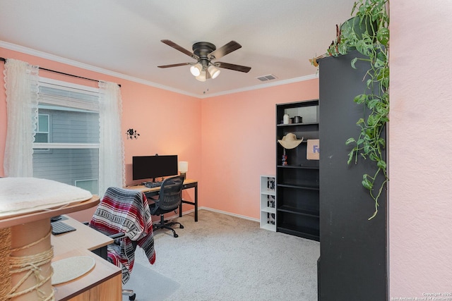 carpeted office featuring ornamental molding and ceiling fan