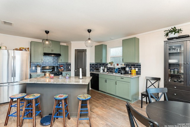 kitchen featuring stainless steel refrigerator, green cabinets, and stove