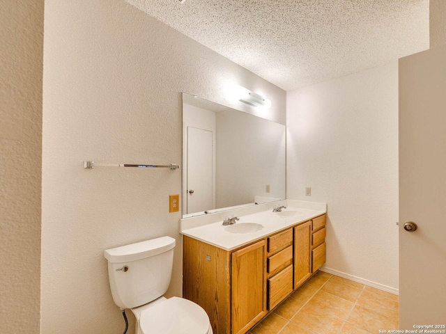 bathroom featuring tile patterned flooring, vanity, a textured ceiling, and toilet