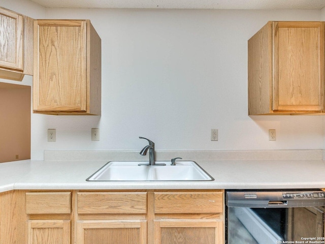 kitchen with dishwasher, sink, and light brown cabinets