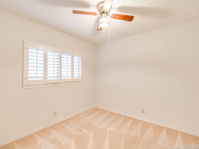 carpeted empty room featuring ceiling fan and a textured ceiling