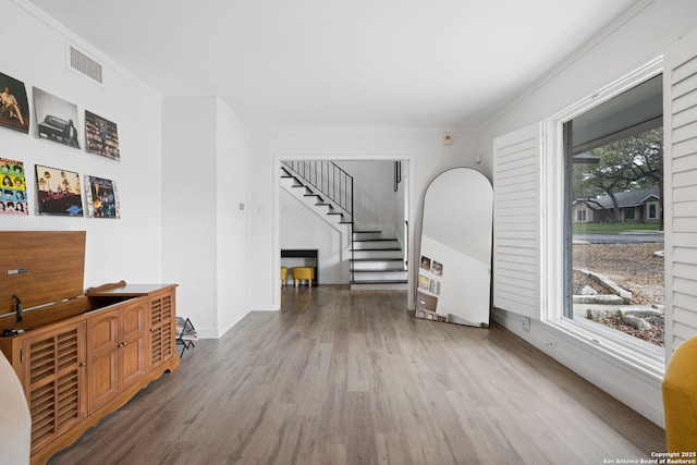 interior space featuring crown molding and hardwood / wood-style flooring