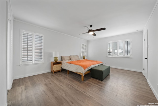 bedroom featuring ornamental molding, ceiling fan, and light hardwood / wood-style flooring