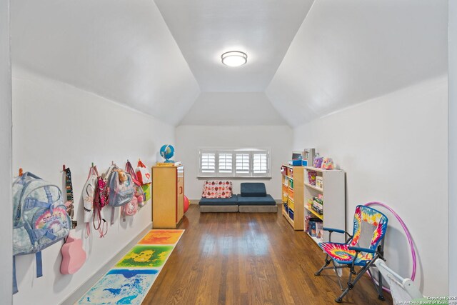 game room featuring vaulted ceiling and dark hardwood / wood-style floors