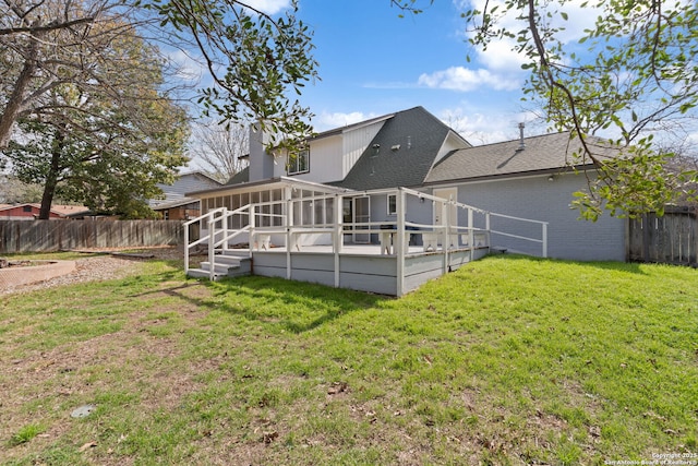 rear view of property with a yard and a sunroom