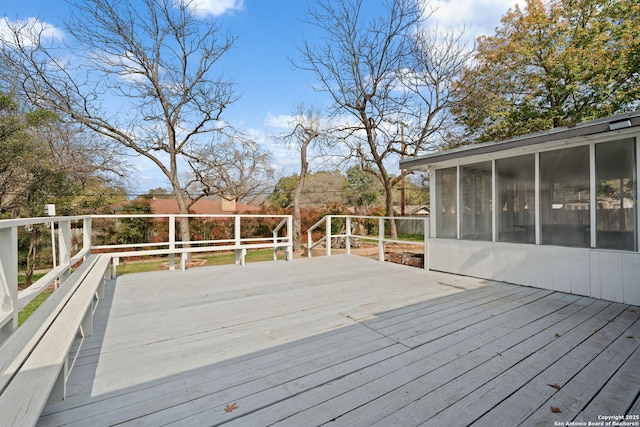 wooden deck featuring a sunroom