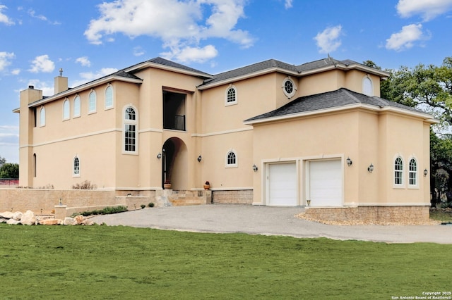 rear view of property featuring a yard and a garage