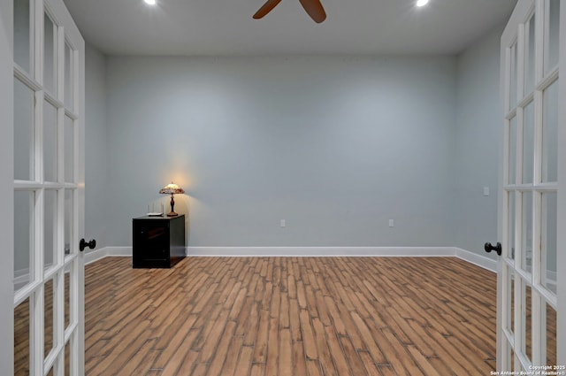 interior space featuring wood-type flooring, french doors, and ceiling fan