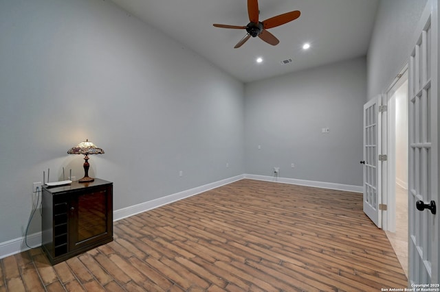 spare room featuring wood-type flooring and ceiling fan