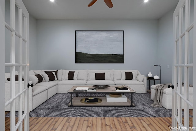 living room with ceiling fan and hardwood / wood-style floors