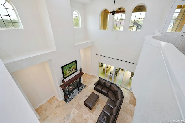 interior space with a high ceiling and ceiling fan