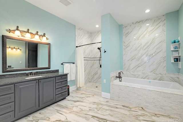 bathroom featuring vanity and independent shower and bath