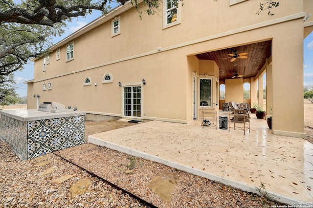 back of house featuring a patio area, ceiling fan, and an outdoor kitchen