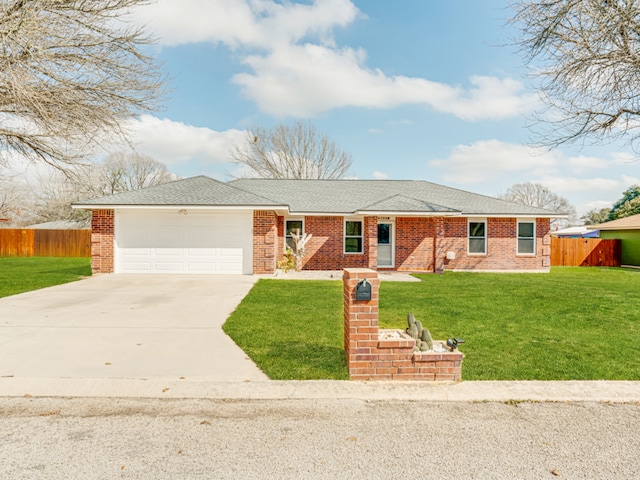 single story home featuring a garage and a front lawn