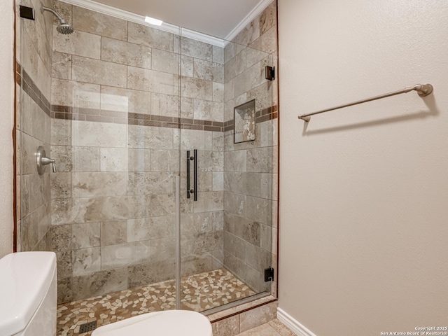 bathroom featuring crown molding, an enclosed shower, and toilet