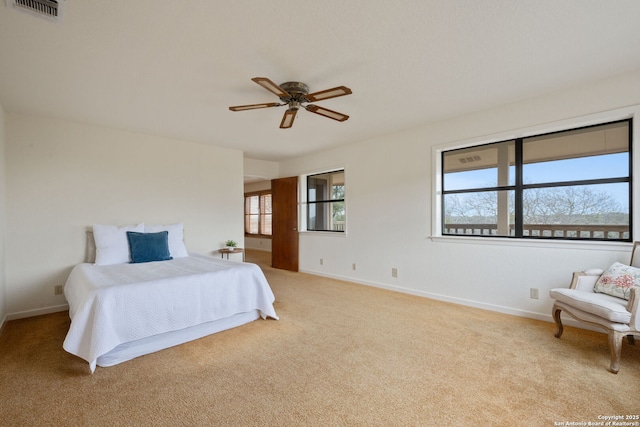 bedroom featuring ceiling fan, light colored carpet, visible vents, and baseboards