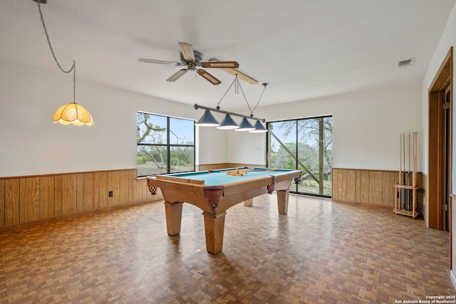 playroom with visible vents, wainscoting, plenty of natural light, and wooden walls