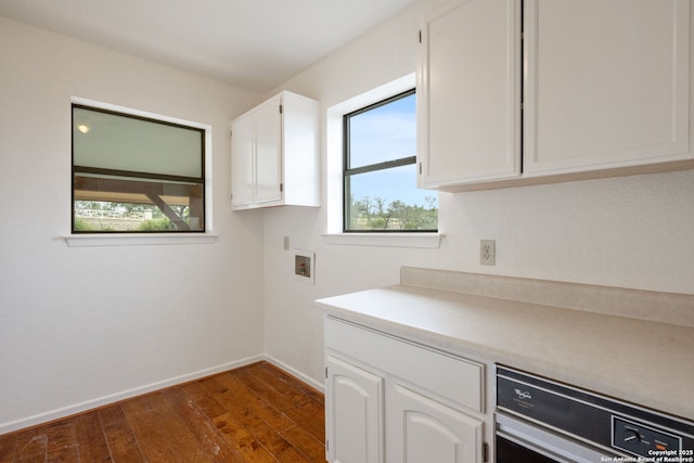 washroom featuring dark wood-type flooring, washer hookup, and baseboards