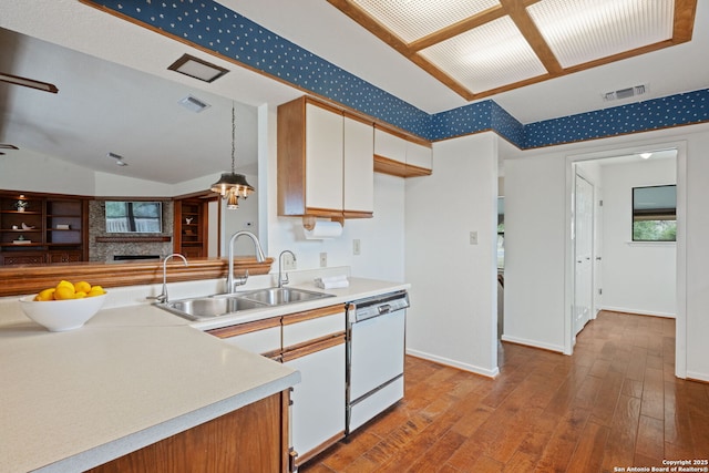 kitchen with visible vents, white cabinets, dishwasher, hanging light fixtures, and light countertops