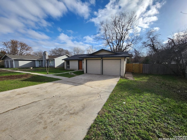 view of front of house featuring concrete driveway, an attached garage, fence, a front yard, and brick siding