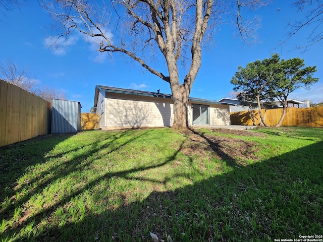 view of yard with a fenced backyard