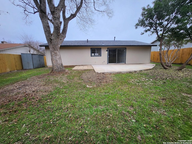 rear view of property with a patio area, a fenced backyard, and a lawn