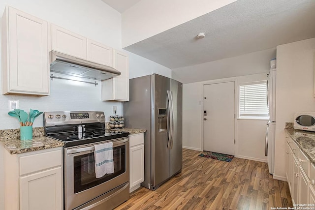 kitchen featuring white cabinetry, appliances with stainless steel finishes, and stone counters