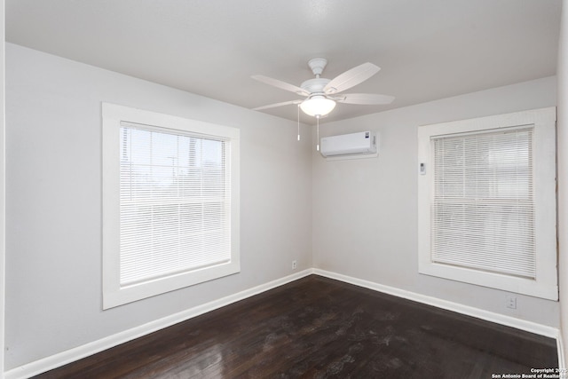 empty room with ceiling fan, dark hardwood / wood-style floors, and an AC wall unit