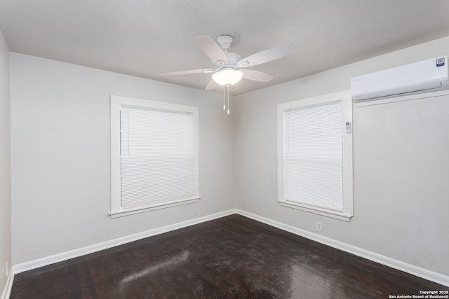 empty room with wood-type flooring, a wall mounted air conditioner, and ceiling fan