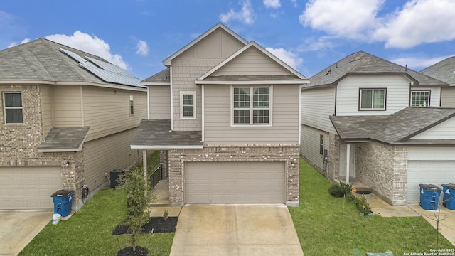 view of front facade with central AC, a garage, and a front lawn