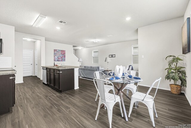 dining room with dark wood-type flooring and sink