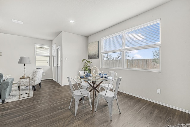 dining area featuring plenty of natural light and dark hardwood / wood-style flooring