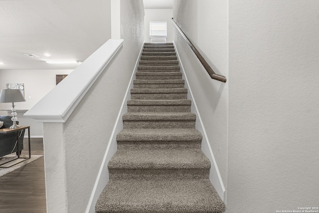 stairs featuring wood-type flooring