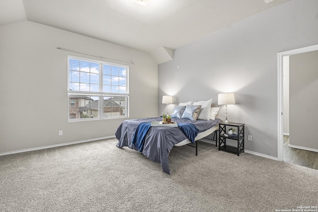 bedroom featuring lofted ceiling and carpet floors