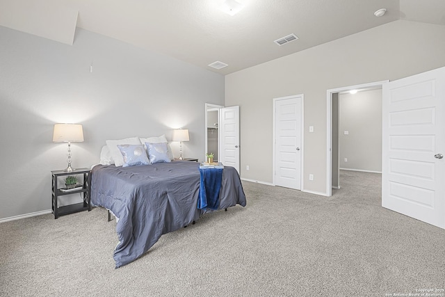 carpeted bedroom featuring lofted ceiling