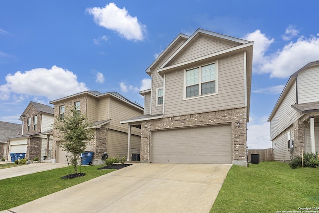 view of front of property featuring a garage, a front yard, and central air condition unit