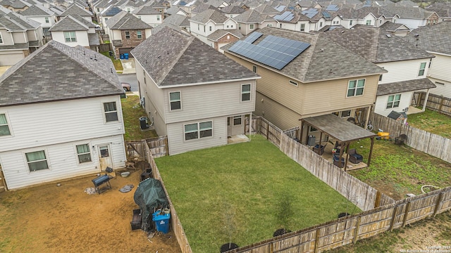 rear view of property featuring a lawn