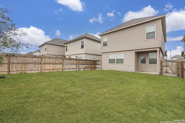 rear view of property with a lawn