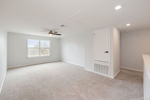 unfurnished room featuring attic access, visible vents, and light carpet