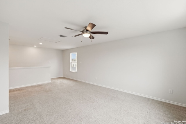 unfurnished room with light carpet, visible vents, and baseboards