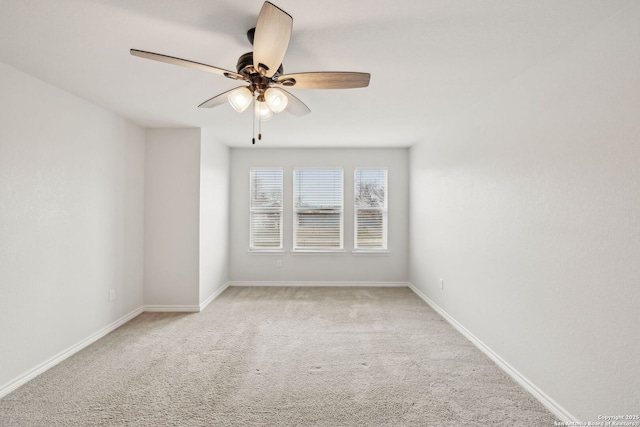 unfurnished room with a ceiling fan, light carpet, and baseboards