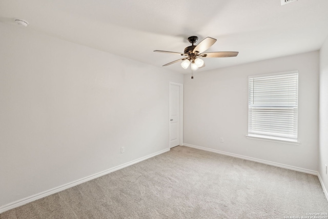 unfurnished room featuring visible vents, carpet flooring, a ceiling fan, and baseboards