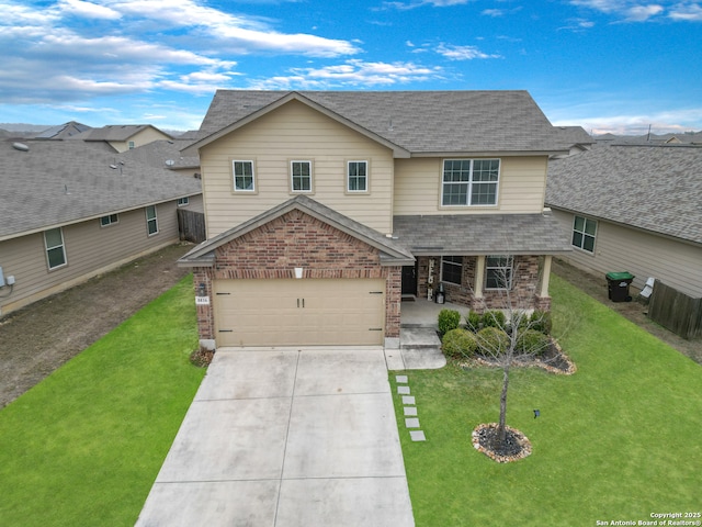 view of front of property featuring a garage and a front lawn