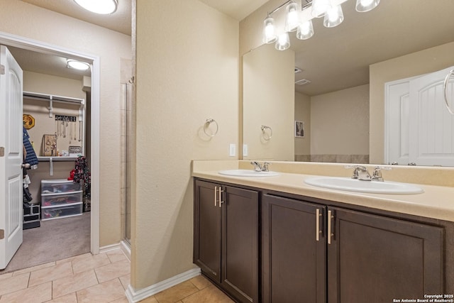 bathroom with tile patterned flooring, vanity, and an enclosed shower