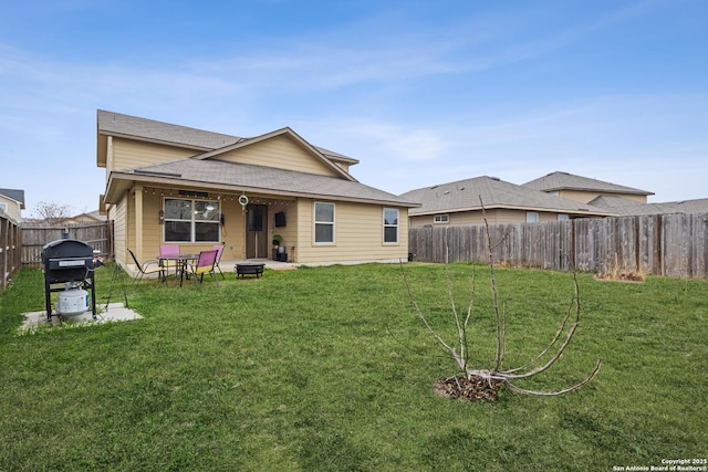 rear view of property with a lawn