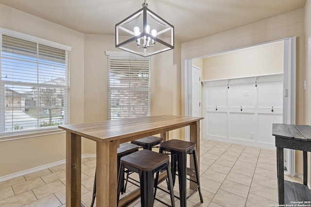 tiled dining area with an inviting chandelier