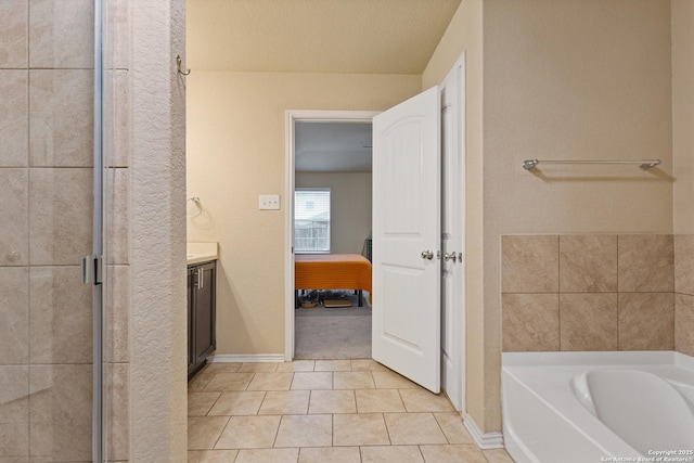 bathroom with vanity, tile patterned flooring, and separate shower and tub