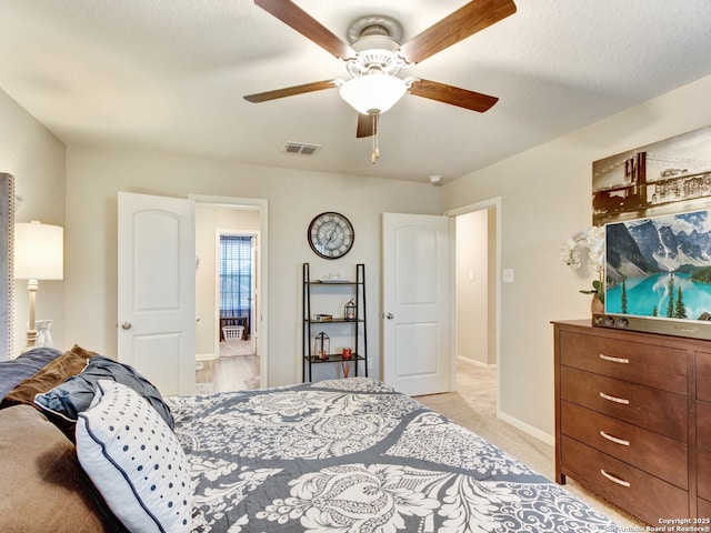 carpeted bedroom with ceiling fan and a textured ceiling