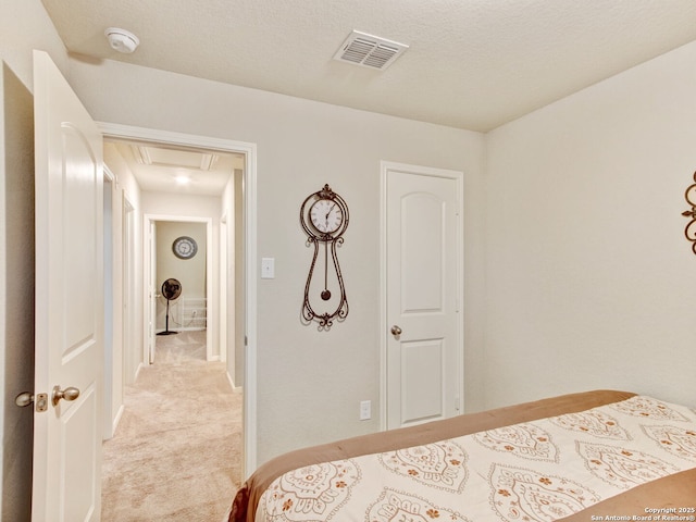 carpeted bedroom featuring a textured ceiling